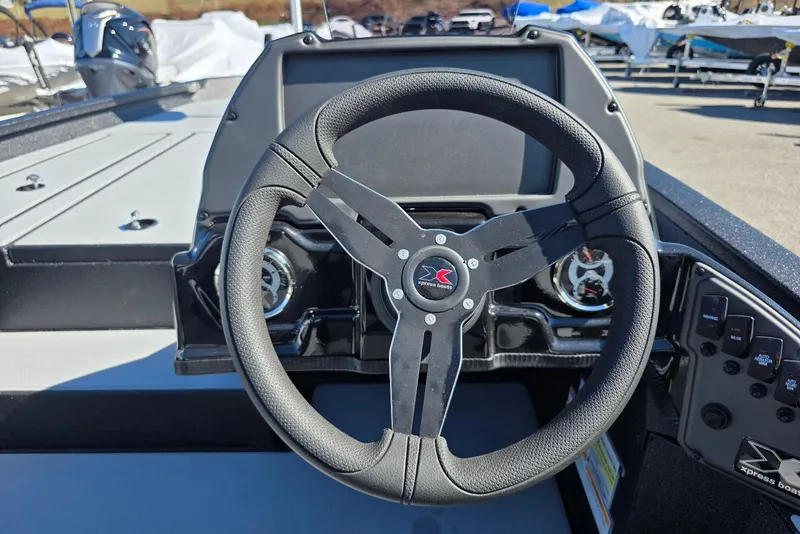 Slide: The Image of Steering wheel of 2026 Xpress H20 Bass boat, featuring modern dashboard controls. - 17
