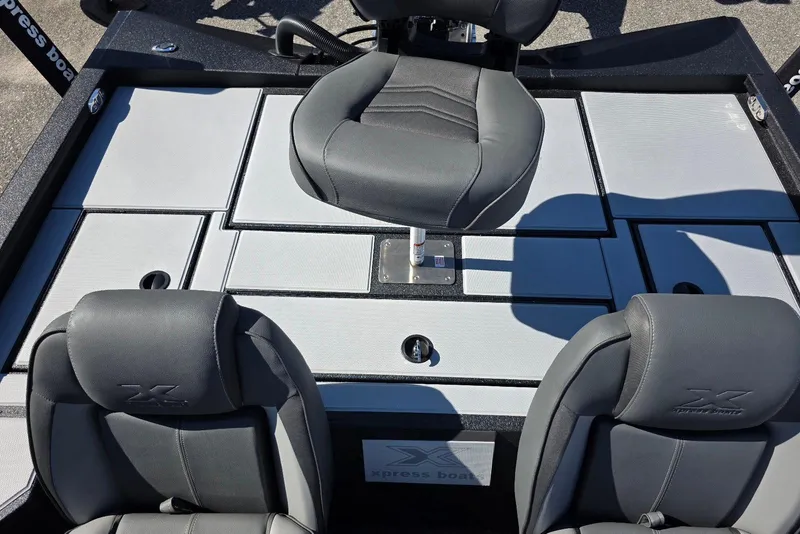 Slide: The Image of 2026 Xpress H20 Bass boat interior with gray seating and storage compartments. - 20