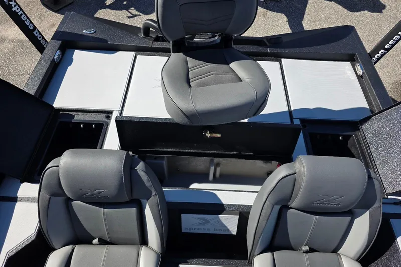 Slide: The Image of 2026 Xpress H20 Bass boat interior with gray seating and storage compartments. - 21