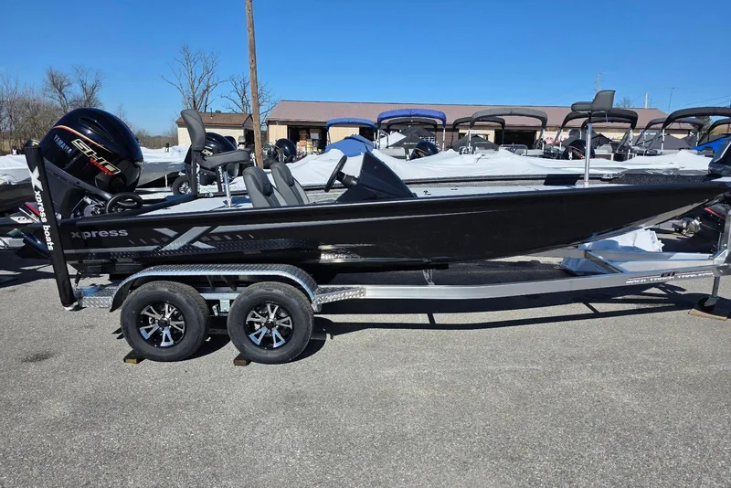 The Image of 2026 Xpress H20 Bass boat on trailer, featuring sleek black design and Yamaha engine. - 3