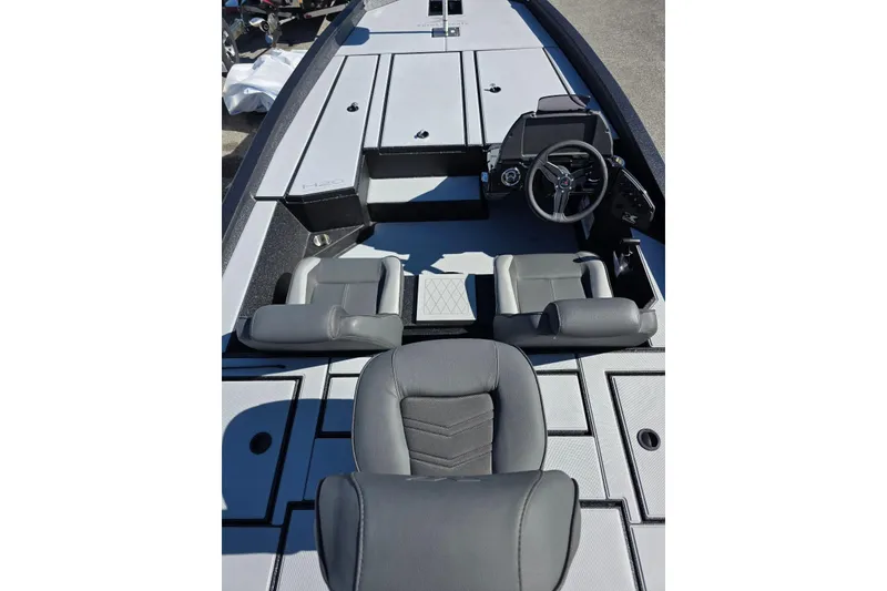 Slide: The Image of 2026 Xpress H20 Bass boat interior with gray seating and steering console. - 8