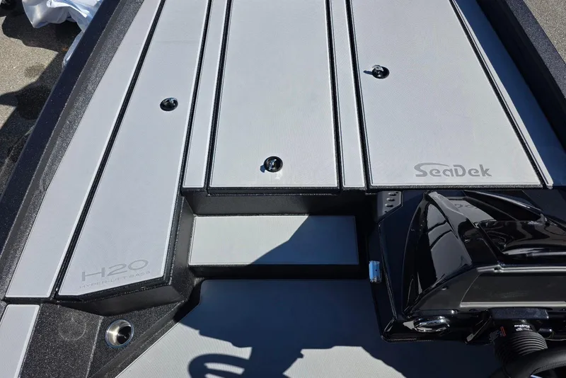 Slide: The Image of 2026 Xpress H20 Bass boat deck with SeaDek flooring, featuring sleek design and modern finish. - 9