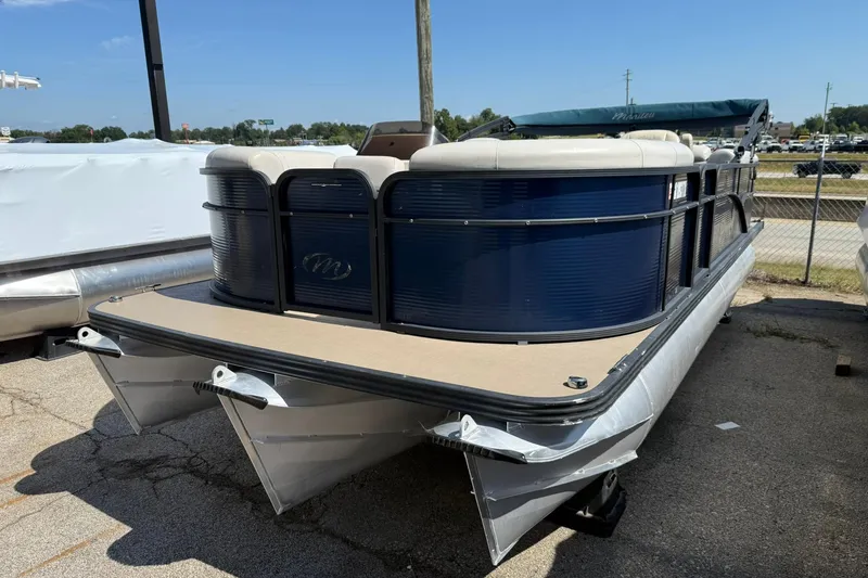 Slide: The Image of 2020 Manitou 21 Aurora LE pontoon boat with blue exterior, parked outdoors. - 3
