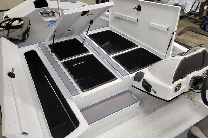 Slide: The Image of 2026 Xpress H20 Bass boat interior with open storage compartments and control panel. - 3