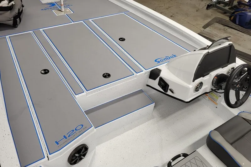 Slide: The Image of 2026 Xpress H20 Bass boat interior with SeaDek flooring and modern console design. - 4