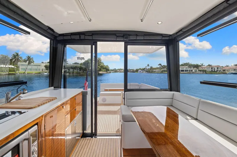 Slide: The Image of Interior view of 2024 MJM 42 yacht with elegant seating and waterfront backdrop. - 13