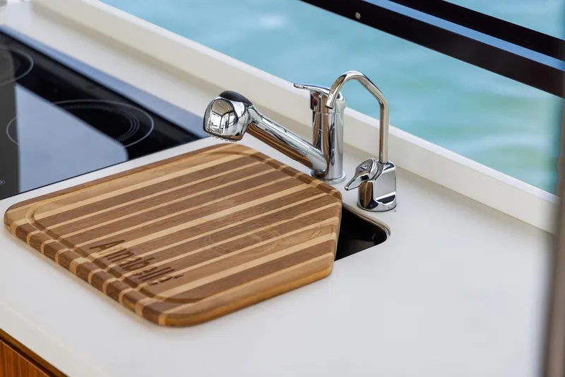 Slide: The Image of Modern kitchen area on 2024 MJM 42 yacht with sink and cutting board. - 16