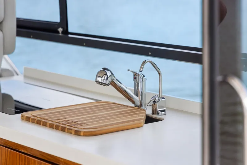 Slide: The Image of Modern kitchen sink area on 2024 MJM 42 yacht with cutting board and faucet. - 17