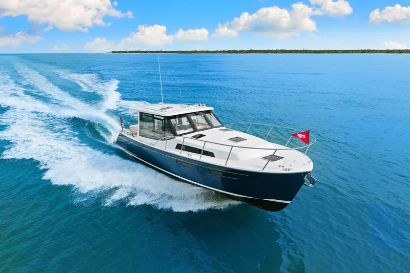 Slide: The Image of 2024 MJM 42 yacht cruising on clear blue ocean under a bright sky. - 2