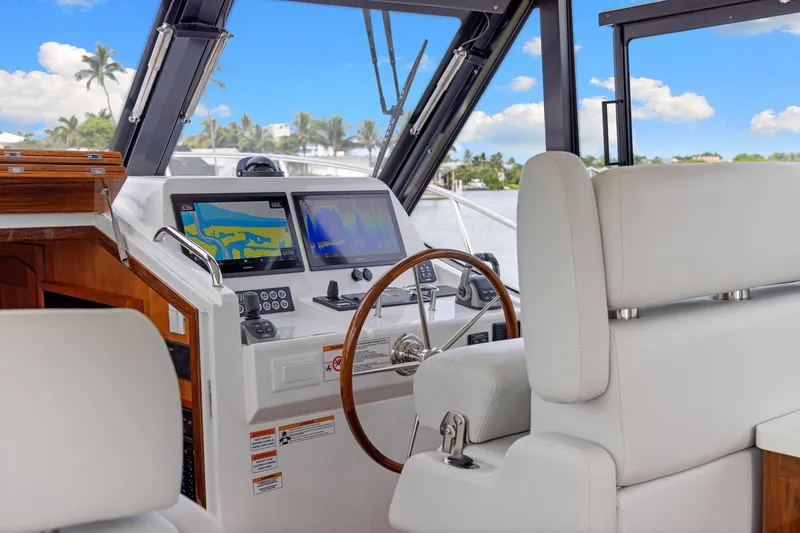 Slide: The Image of 2024 MJM 42 yacht helm with modern navigation displays and luxurious seating. - 26