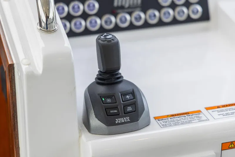 Slide: The Image of Joystick control on 2024 MJM 42 boat dashboard with Volvo Penta branding. - 35