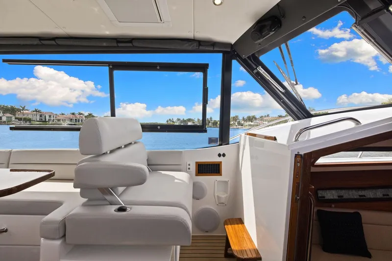 Slide: The Image of 2024 MJM 42 yacht interior with luxurious seating and scenic waterfront view. - 39