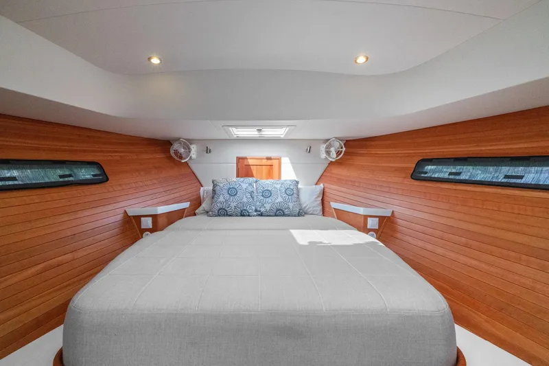 Slide: The Image of Luxurious cabin interior of 2024 MJM 42 yacht with wood paneling and cozy bedding. - 40