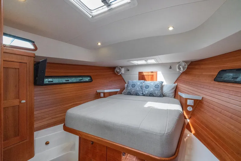 Slide: The Image of Luxurious cabin interior of 2024 MJM 42 yacht with cozy bed and wooden accents. - 41