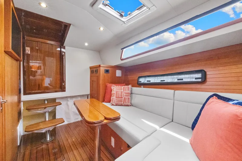 Slide: The Image of Luxurious interior of 2024 MJM 42 yacht with wooden accents and plush seating. - 50