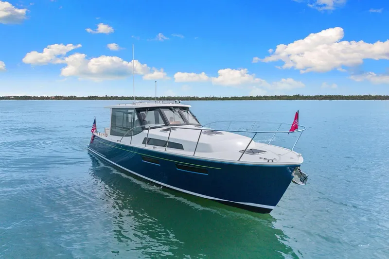 Slide: The Image of 2024 MJM 42 yacht cruising on calm blue waters under a clear sky. - 59