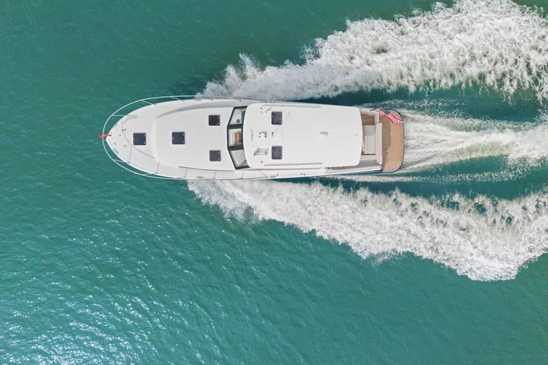 Slide: The Image of Aerial view of 2024 MJM 42 yacht cruising on turquoise water. - 67