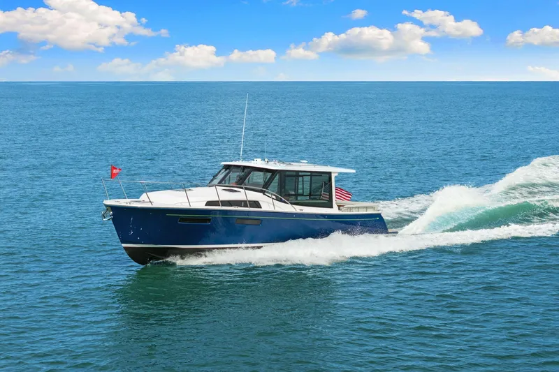 Slide: The Image of 2024 MJM 42 yacht cruising on open sea under clear blue sky. - 69