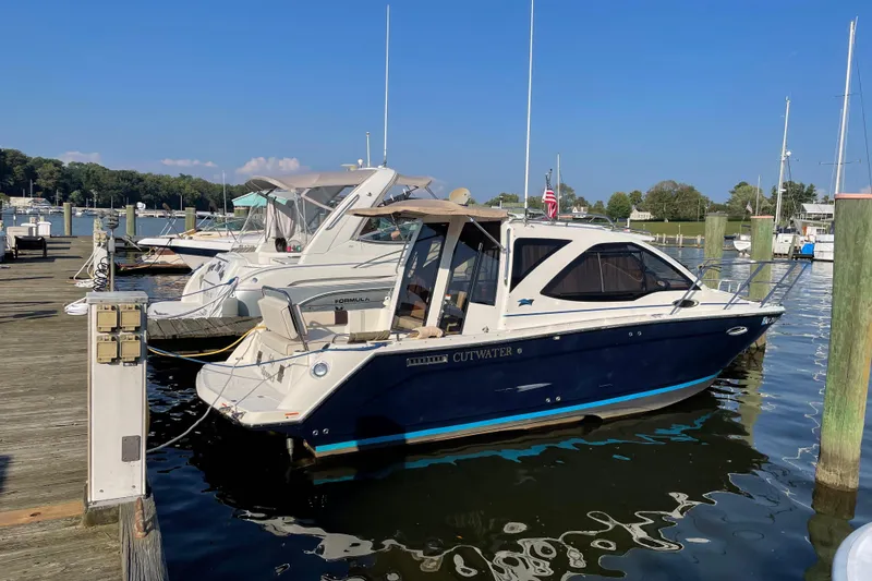 Slide: The Image of 2016 Cutwater C-24 Coupe docked at a marina on a sunny day. - 10
