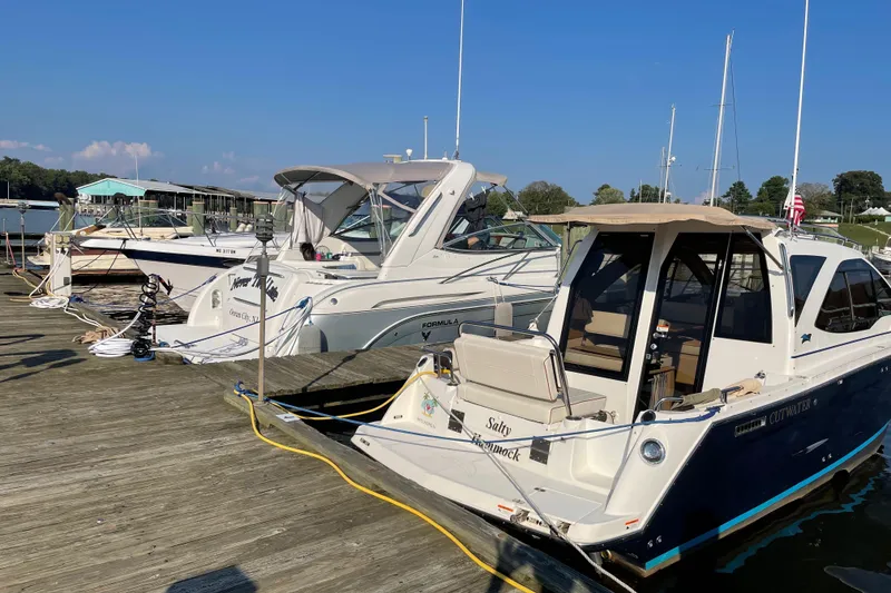 Slide: The Image of Boats docked at a marina, featuring a 2016 Cutwater C-24 Coupe. - 11