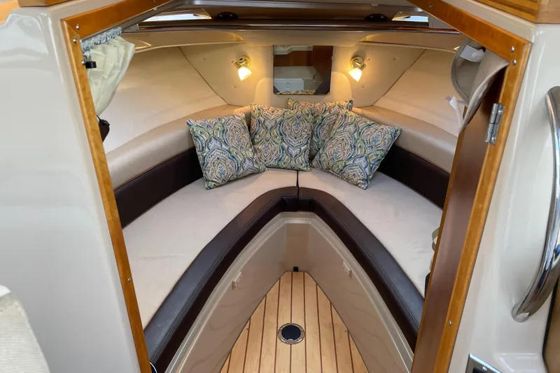 Slide: The Image of 2016 Cutwater C-24 Coupe cabin interior with cozy seating and decorative pillows. - 14