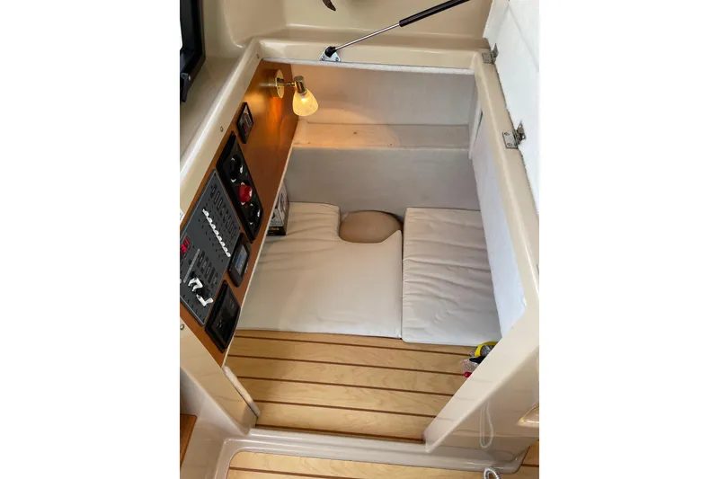 Slide: The Image of 2016 Cutwater C-24 Coupe cabin interior with control panel and cozy sleeping area. - 20