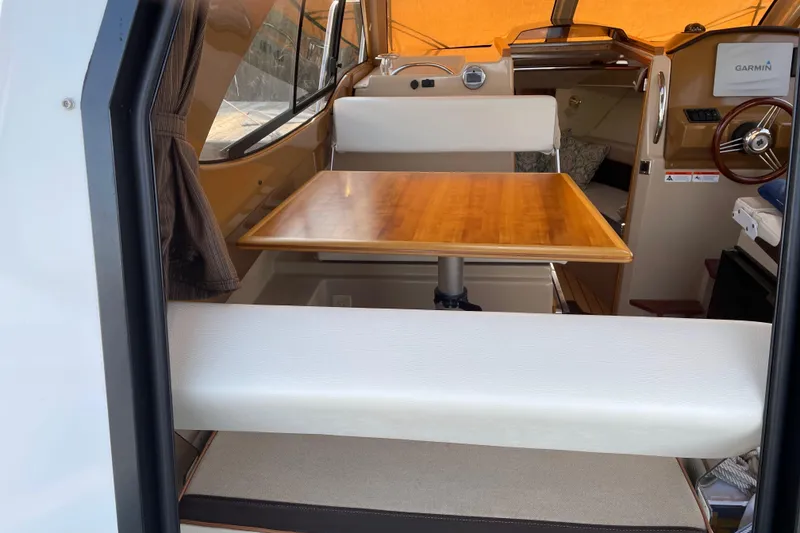 Slide: The Image of Interior of 2016 Cutwater C-24 Coupe with wooden table and seating area. - 21
