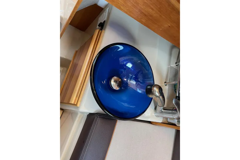 Slide: The Image of Blue glass sink in 2016 Cutwater C-24 Coupe boat interior. - 23