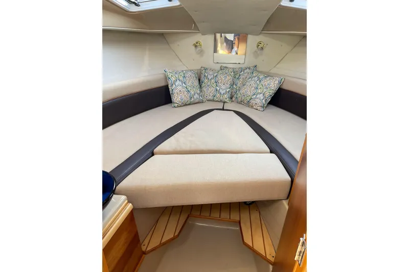 Slide: The Image of 2016 Cutwater C-24 Coupe interior cabin with cozy seating and decorative pillows. - 25