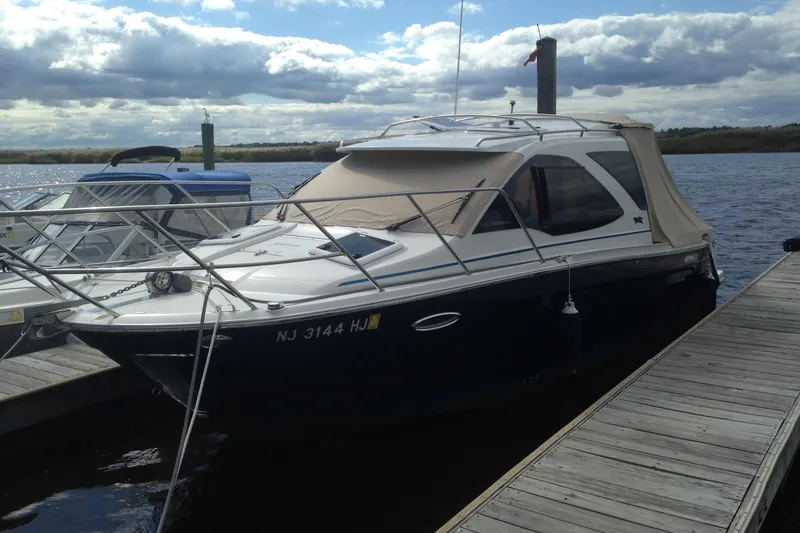 Slide: The Image of 2016 Cutwater C-24 Coupe docked at a marina under cloudy skies. - 6