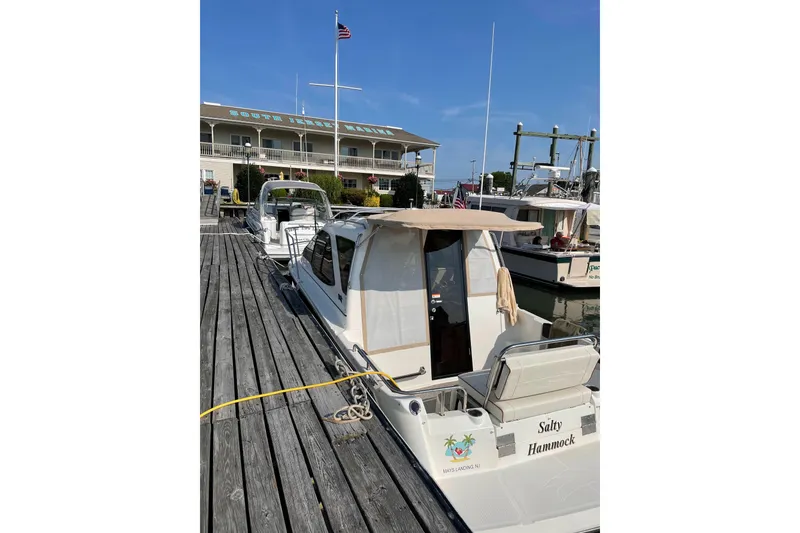 Slide: The Image of 2016 Cutwater C-24 Coupe docked at South Jersey Marina under clear blue skies. - 9
