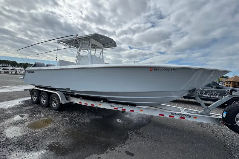 The Image of 2022 Contender 32 ST boat on trailer under cloudy sky. - 1
