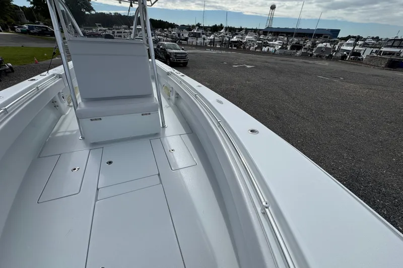 Slide: The Image of 2022 Contender 32 ST boat interior at marina, showcasing spacious deck and seating. - 12