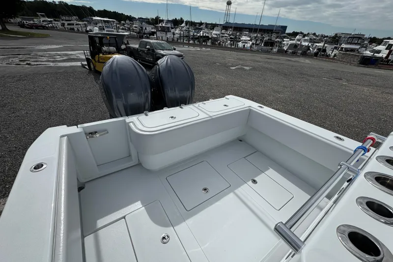 Slide: The Image of 2022 Contender 32 ST boat with dual engines at a marina. - 15