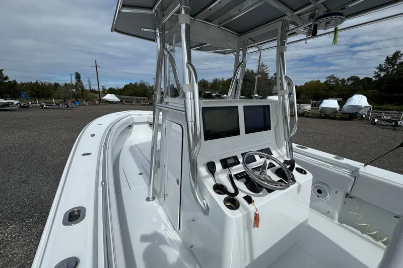 Slide: The Image of 2022 Contender 32 ST boat with modern helm and dual displays, parked outdoors. - 17