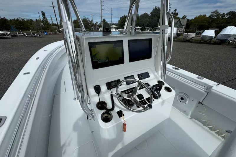 Slide: The Image of 2022 Contender 32 ST boat console with navigation screens and steering wheel. - 19