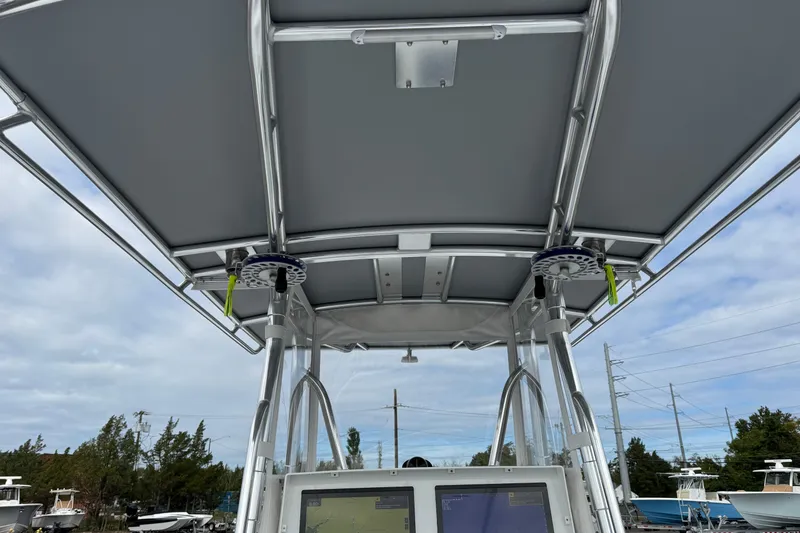 Slide: The Image of 2022 Contender 32 ST boat with T-top and navigation equipment, under a cloudy sky. - 20