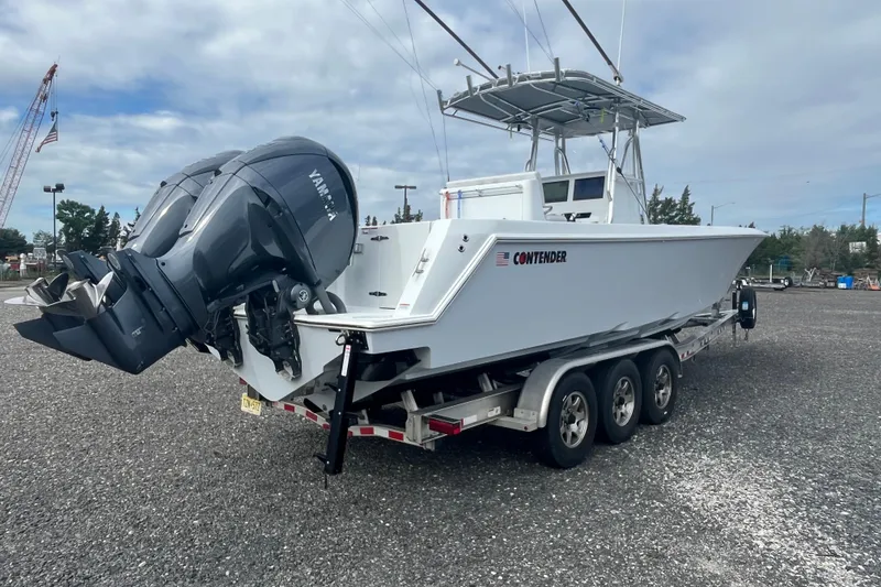 Slide: The Image of 2022 Contender 32 ST boat on trailer with dual Yamaha outboard engines. - 5