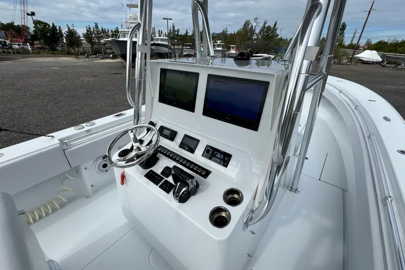 Slide: The Image of 2022 Contender 32 ST boat console with steering wheel and navigation screens. - 8