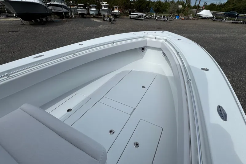 Slide: The Image of 2022 Contender 32 ST boat interior with sleek white deck and seating. - 9