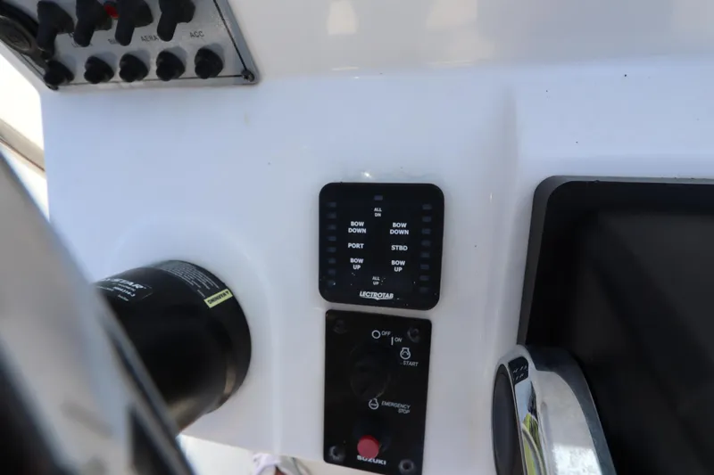 Slide: The Image of Control panel of 2022 Sundance DX22 boat with switches and indicators. - 10
