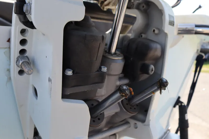 Slide: The Image of Close-up of 2022 Sundance DX22 engine components with visible bolts and mechanical parts. - 15