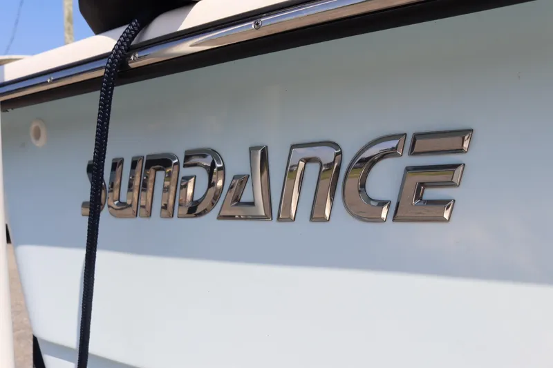 Slide: The Image of 2022 Sundance DX22 boat logo with chrome lettering on the hull. - 4