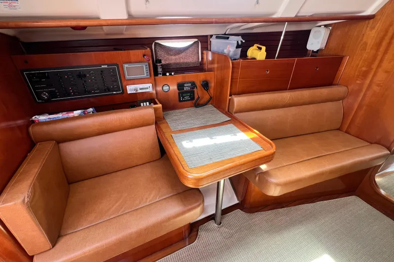 Slide: The Image of Interior of 1996 Beneteau Oceanis 400 sailboat with wood finish and leather seating. - 13