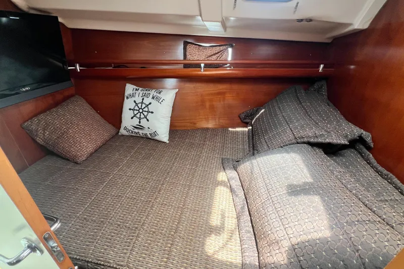 Slide: The Image of Cozy cabin interior of 1996 Beneteau Oceanis 400 sailboat with pillows and bedding. - 14