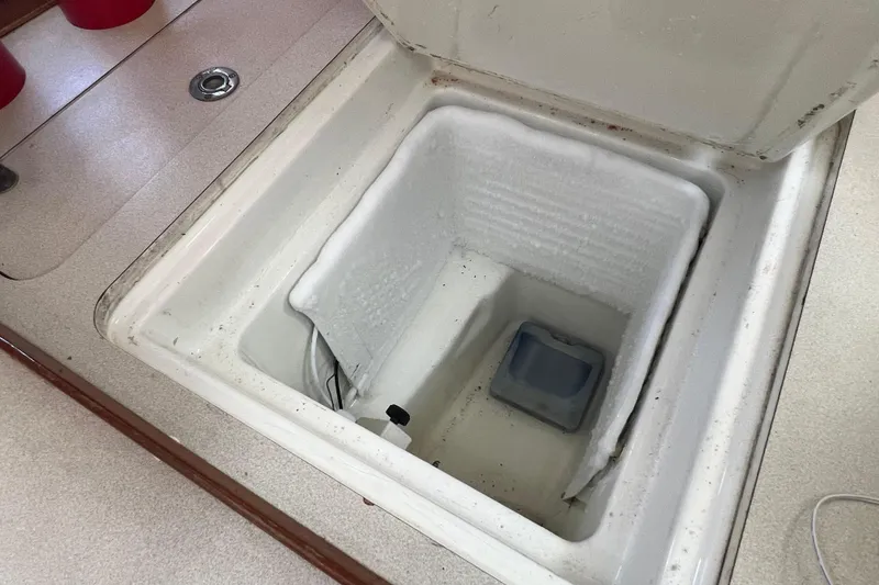 Slide: The Image of Open icebox in 1996 Beneteau Oceanis 400 sailboat galley, showing interior storage space. - 17