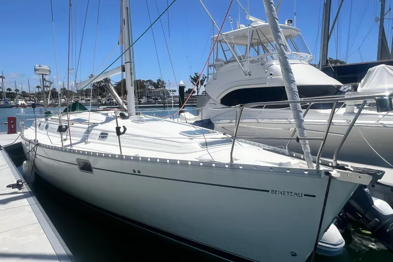 Slide: The Image of 1996 Beneteau Oceanis 400 sailboat docked in a marina under clear blue skies. - 2