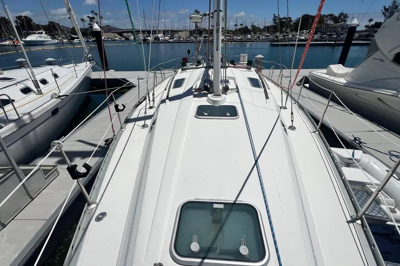 Slide: The Image of 1996 Beneteau Oceanis 400 sailboat docked at a marina, viewed from the deck. - 5