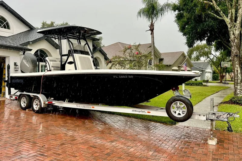 Slide: The Image of 2020 ShearWater 260 Carolina Flare boat cruising on open water, creating a dynamic wake. - 2