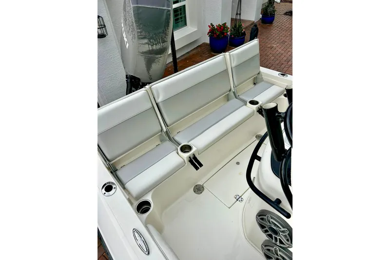 Slide: The Image of 2020 ShearWater 260 Carolina Flare boat interior with cushioned seating and cup holders. - 28